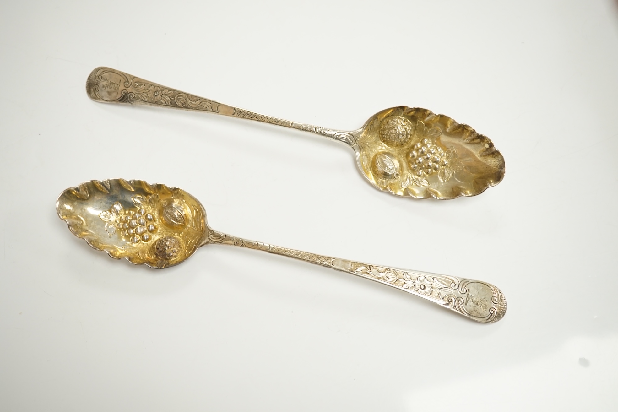 A group of assorted silver including a George III Irish silver basing spoon, Dublin, 1804, 29.5cm, a similar sauce ladle, two Georgian berry spoons, a late Victorian heart shaped photograph frame, a heart shaped pill box